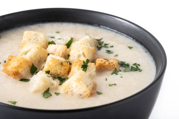 istock Cauliflower soup in a bowl isolated on white background 1530427900