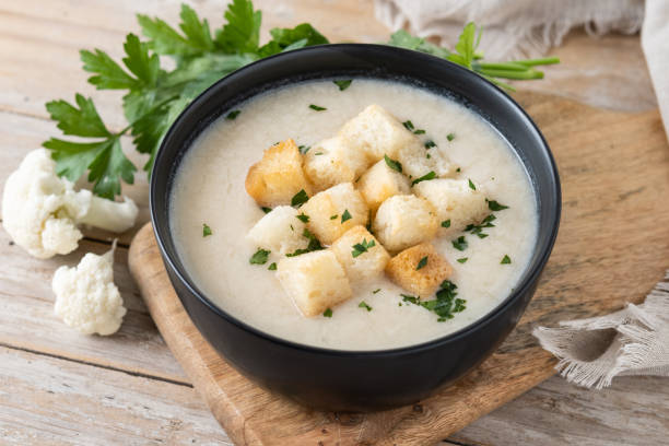 istock Cauliflower soup in a bowl on wooden table 1530428776