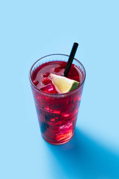 istock Cape Codder cocktail with vodka, cranberry juice and lime on blue background 1530438223
