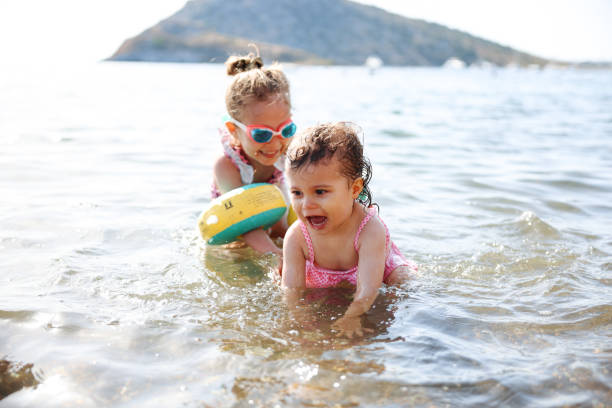 Free Stock Photo of Two Little Girls Playing in the Water at the Beach ...