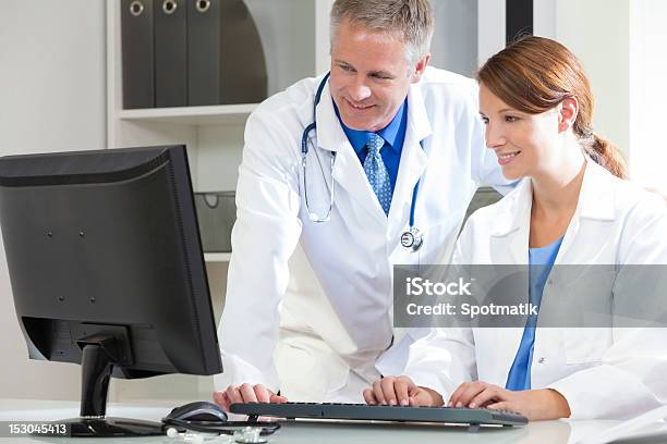 Male Female Hospital Doctors Using Computer Stock Photo - Download Image Now - 30-39 Years, Adult, Adults Only