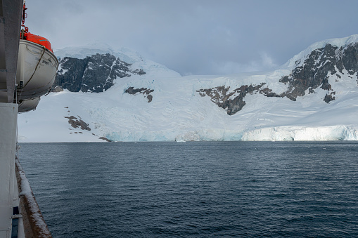Beautiful snow-capped mountains view from ship in Antarctica. High quality photo