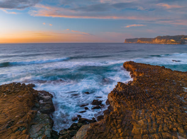 istock Ocean sunrise with rock platform and clouds 1530459576