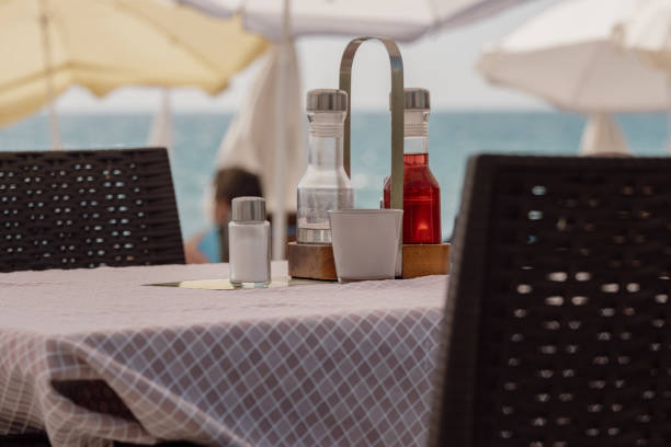 An empty table in a summer cafe by the sea under an umbrella