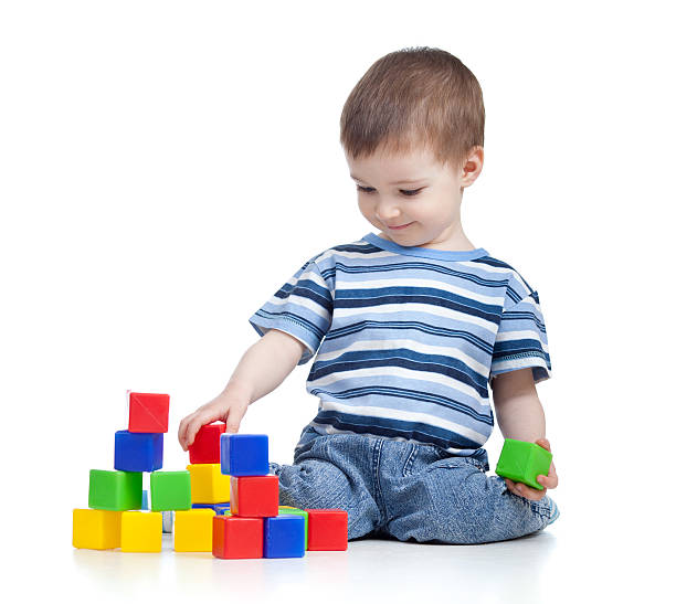 istock cheerful kid boy with construction set over white background 153046585
