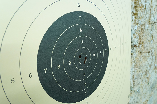 Paper target with a holes from bullet, close-up photo