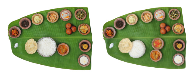 Sumptuous and wholesome onam meals called sadhya in kerala. The lunch contains varieties of curries and vegetable mixes along with papad, sweet appam and kheer. The food is served on a banana leaf