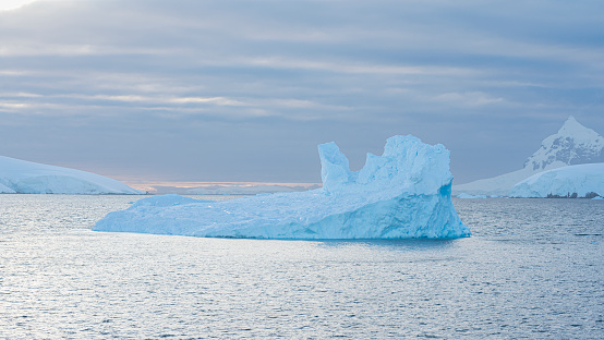 blue water melting over the icebergs in the shape of a heart at Ilulissat Icefjord, Greenland
