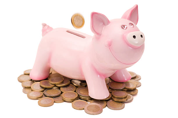 isolado cofre de porquinho rosa com moedas - piggy bank gold british currency pound symbol - fotografias e filmes do acervo