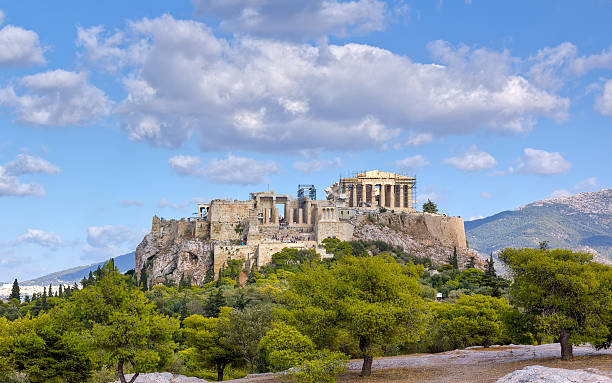 The Acropolis Athens Greece against landscape and cloudy sky View of Acropolis from Pnyx hill acropolis athens photos stock pictures, royalty-free photos & images