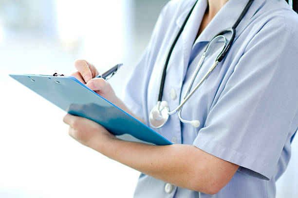 istock Female doctor with clipboard and pen 153053710