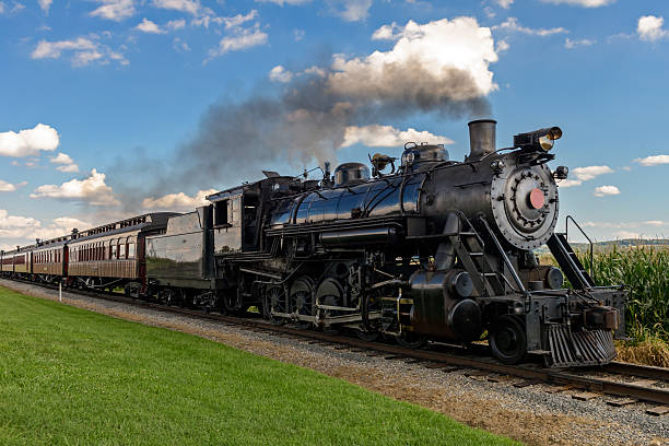 steam train historic steam train passes through the fields locomotive stock pictures, royalty-free photos & images