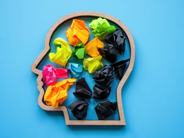 istock Negative and positive thoughts concept. Head shape with color and black paper balls. 1530553931