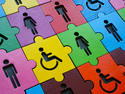 Diversity and inclusion. Multi colored puzzle with figures of people.