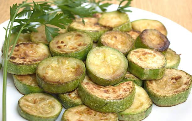 istock Fried zucchini slices with parsley on white plate 153056130