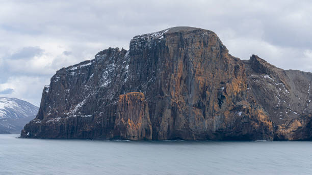 istock Rugged mountains with a dusting of snow at Deception Island, Antarctica 1530567377