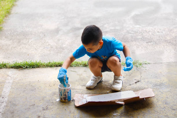 istock The boy paints and helps his parents at home 1530577863