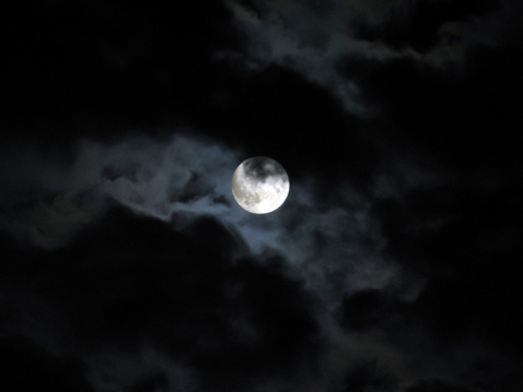 Halloween full moon in dark cloudy night sky