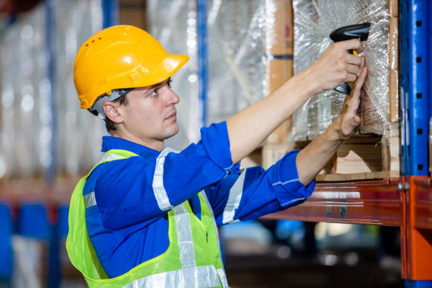 istock man professional worker wearing safety uniform and hard hat worker scanning box inspect product on shelves in warehouse. 1530608819
