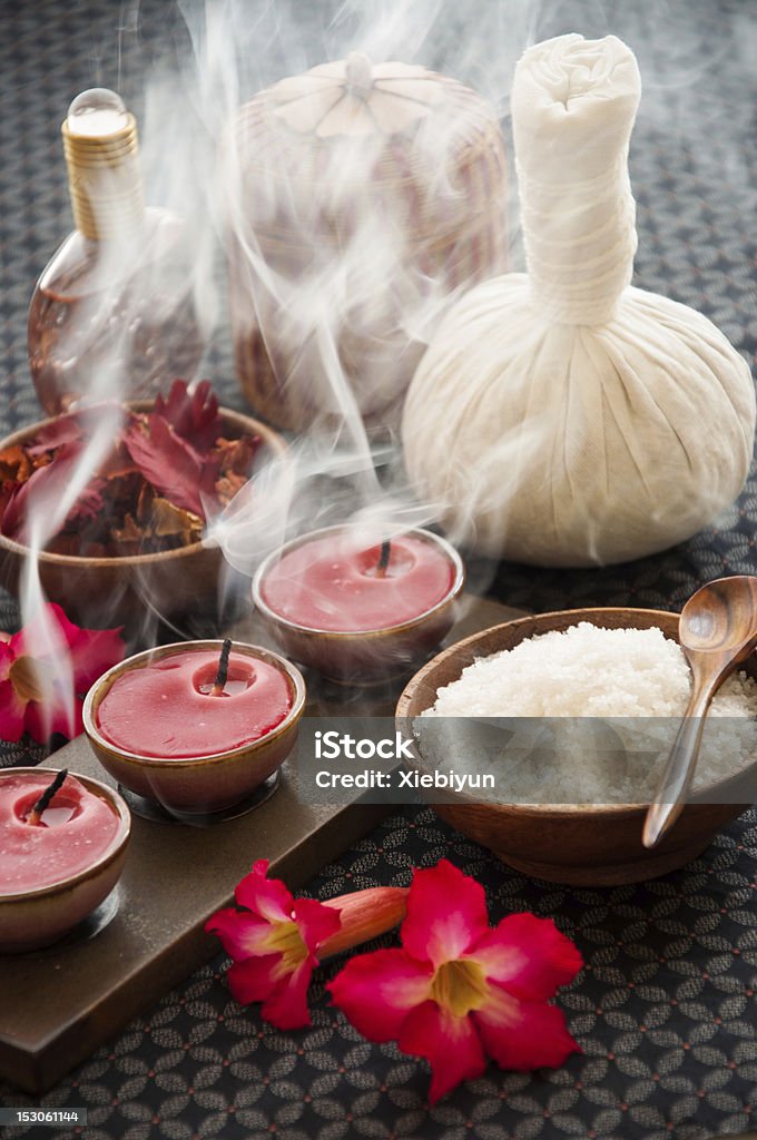 Candles recently extinguished of spa salon Tranquil scene of candles recently extinguished with spa accessories. Herbal Medicine Stock Photo