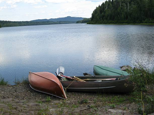 istock Canoes and boat on shore 153061322
