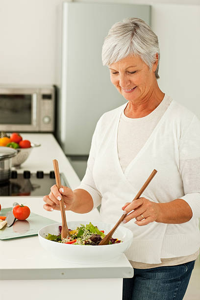 istock Senior woman preparing food in kitchen 153061496