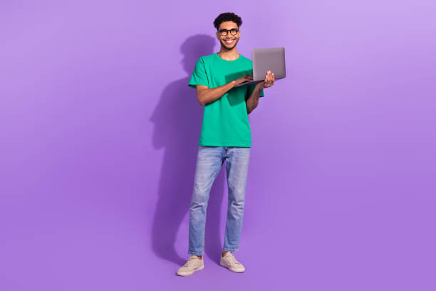 istock Full length photo of young student guy wear glasses hold laptop studying coding future successful programmer isolated on violet background 1530623614