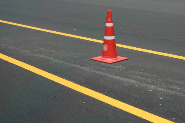 istock orange trafic cone on the parking lot, safety cone, rubber cone 1530632014