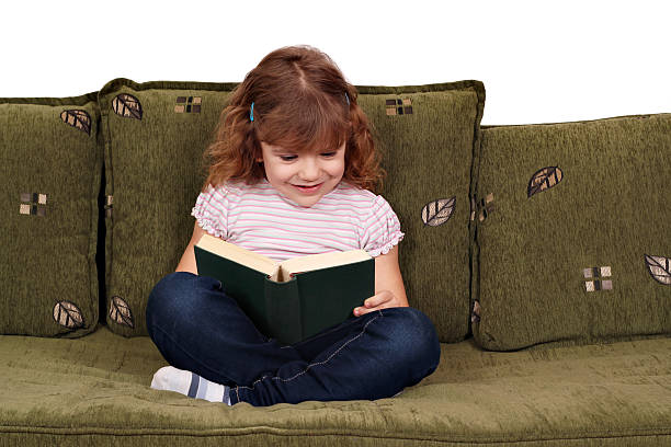 istock little girl reading book 153066338