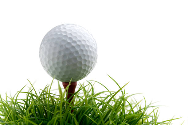 A teed up golf ball on a small patch of green grass