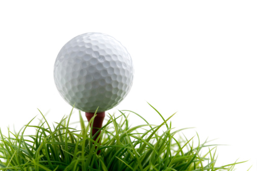 Golf ball on green grass, selective focus