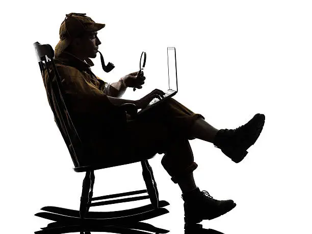 sherlock holmes with computer laptop silhouette sitting in rocking chair in studio on white background