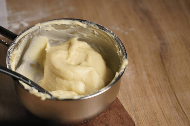 istock female hands mixing choux dough 1530685472