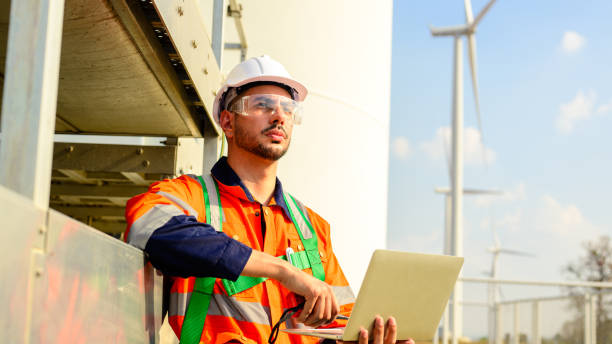 istock Professional engineer using walkie-talkie working at wind turbine farm 1530686884