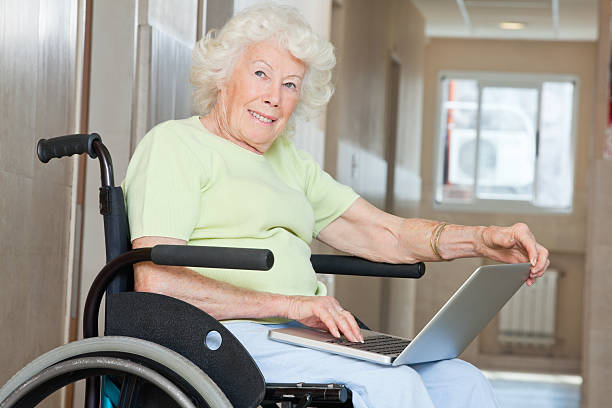 istock Senior Woman In Wheelchair Using Laptop 153069098
