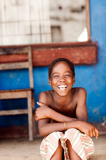 portrait of happy african child with a smile, outdoors in the village
