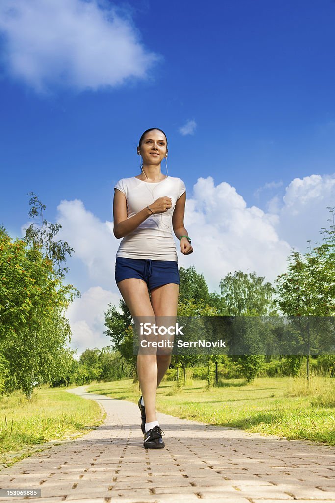 slim tall girl running in the park attractive runner in the perfect shape in the park Active Lifestyle Stock Photo
