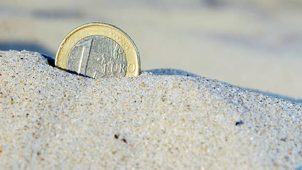 istock Euro coin in the sand 153069897