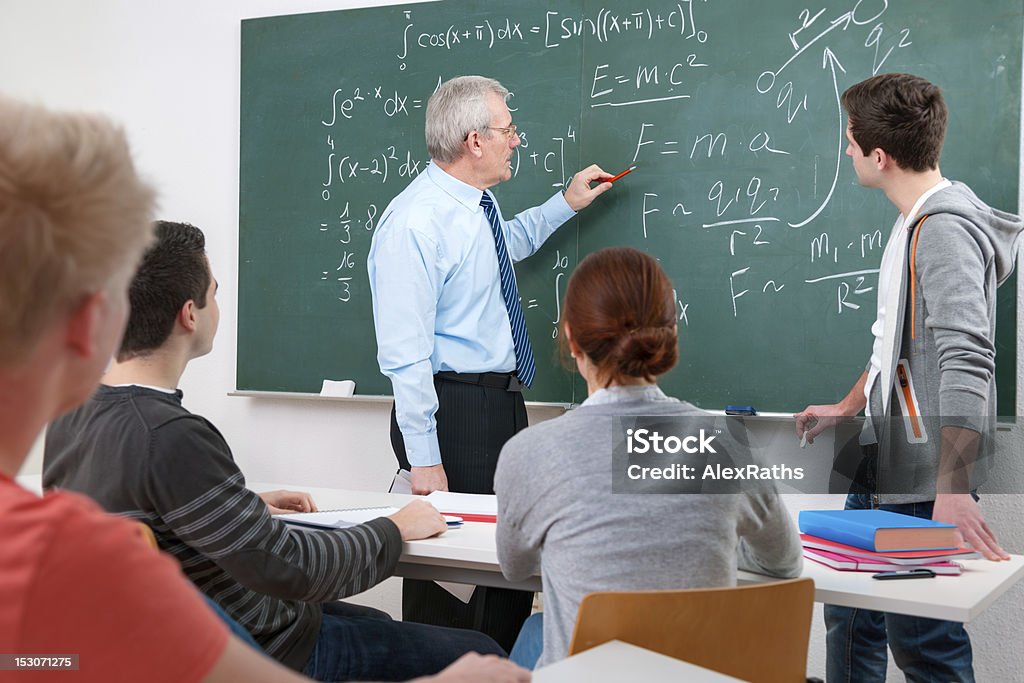 students with a teacher in classroom Mathematics Stock Photo