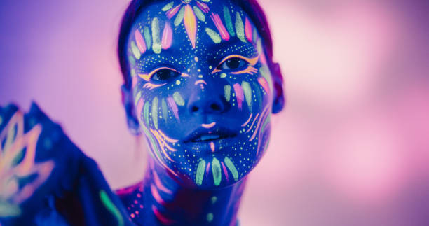 istock Young Woman's Modern Dance Choreography Unfolds on a Dark Stage with Creative Background. Female with Body Art Paint and Immersive Dance Experience Concept 1530715866