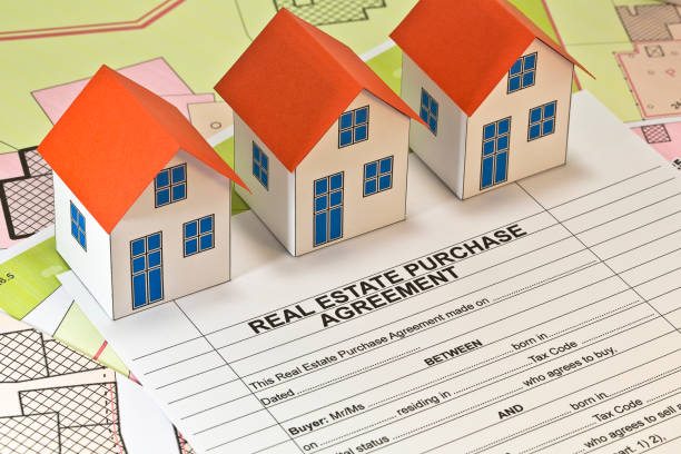 istock Real Estate Purchase Agreement - concept with imaginary cadastral map and residential home model 1530731663