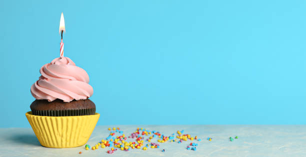 istock Delicious birthday cupcake with candle on light blue background. Space for text 1530740151