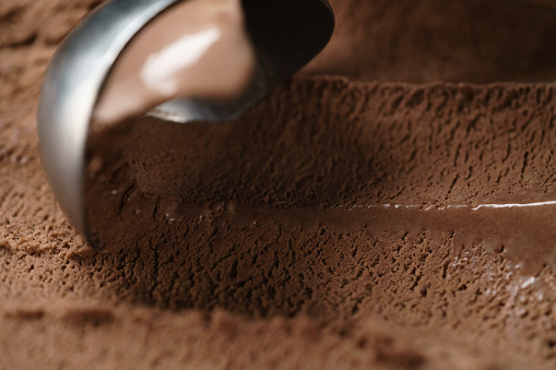 closeup scooping chocolate ice cream, shallow focus