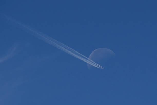 istock Airplane crossing the moon 1530752298
