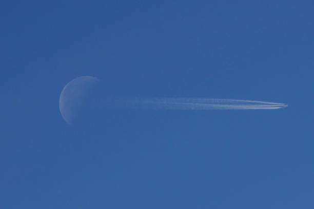 istock Airplane crossing the moon 1530752299