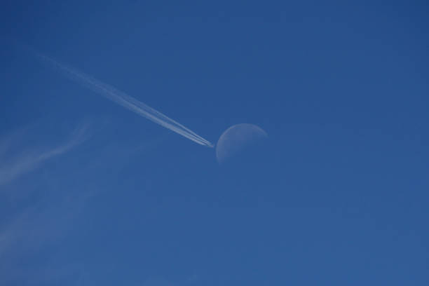 istock Airplane crossing the moon 1530752301