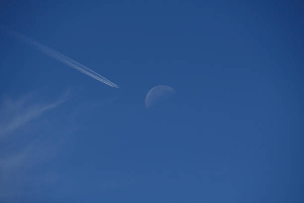 istock Airplane crossing the moon 1530752302