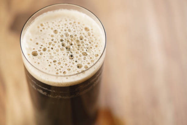 istock dark beer in glass on wood table from above 1530757968