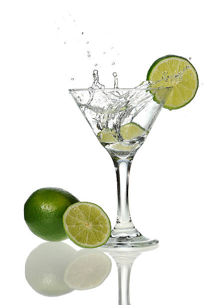 istock Martini glass with wedge of lemon droped 153076682