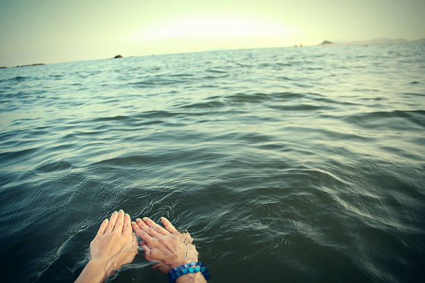 A close up shot of female arms in the sea
